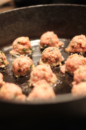 Pan frying the meatballs in cast iron skillet